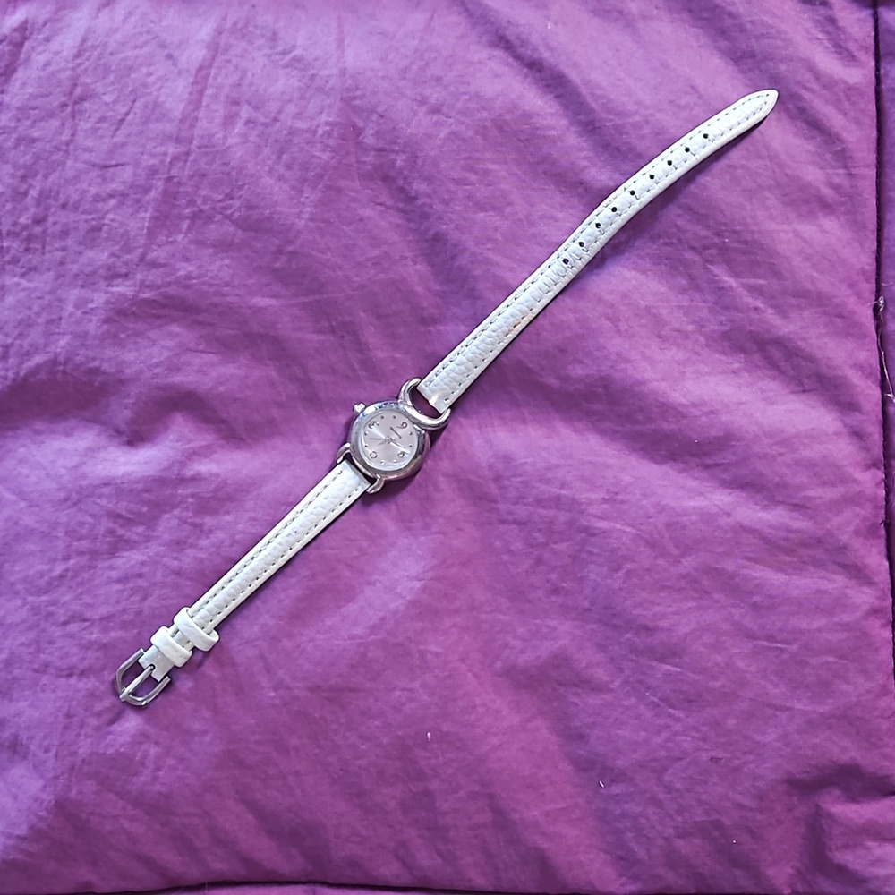 Elegant Avon silver watch with slim white faux leather band & rhinestone at 12